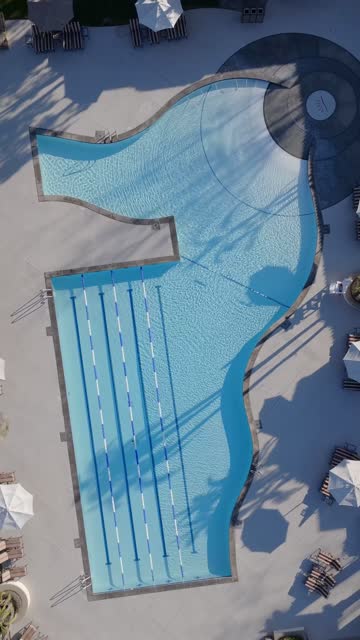 Aerial view of a residential street, open country and the water in Santaluz.