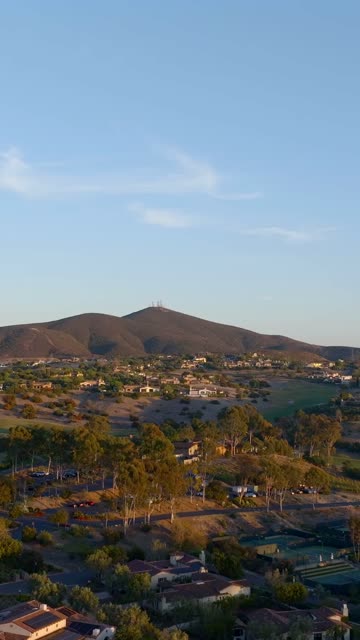 Aerial view of a residential street, homes and open country in Santaluz.