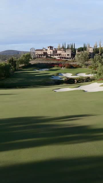 Aerial Drone Video of The Bridges Country Club in Rancho Santa Fe featuring the Golf Course Clubhouse Luxury Homes and Scenic California Landscape Views | Vertical Drone Video