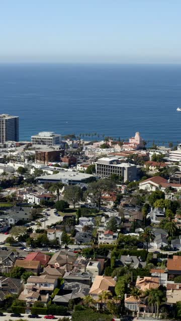 Aerial view of a residential street, boats and palm trees at La Jolla Cove.