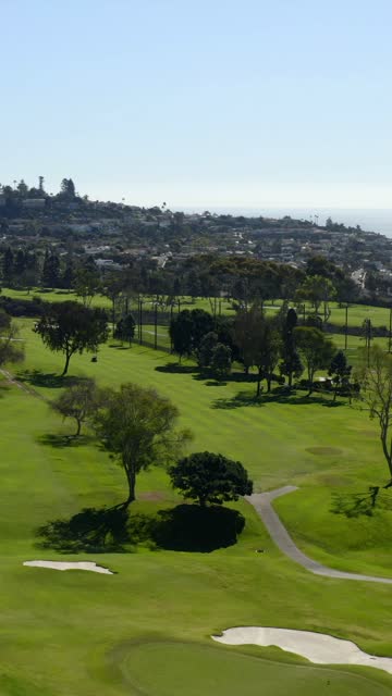 Aerial view of the country inland, the ocean and homes at La Jolla Country Club.