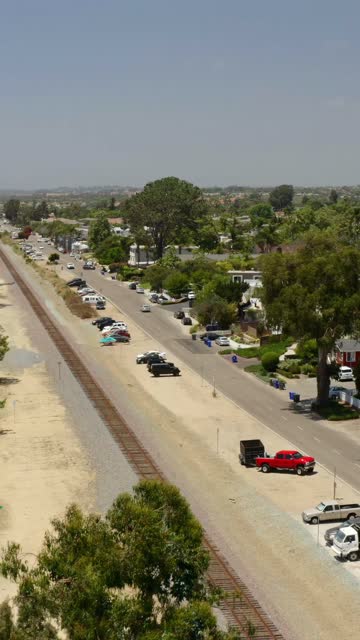 Low aerial view of a residential street, homes and traffic in Encinitas.