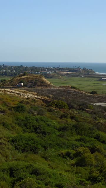 Aerial view of the country inland, the ocean and homes in Cardiff.