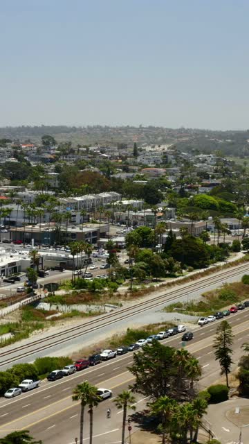Aerial Drone Video capturing the Cardiff by the Sea Neighborhood and Seaside Market with Scenic Coastal Village Pacific Ocean and Southern California Beach Town Views | Vertical Drone Video – 1