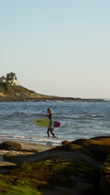 The beach, the surf and the ocean at Beach Barber Tract, with surfers out.