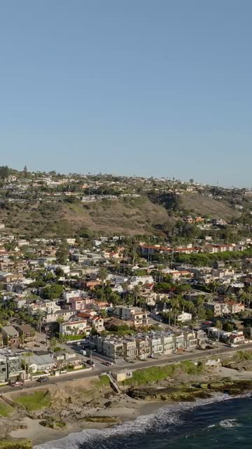 Aerial view of a residential street, palm trees and the ocean at Beach Barber Tract.