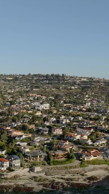 Aerial view of a residential street, homes and the beach at Beach Barber Tract.