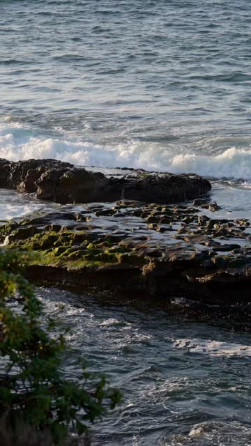 The cliffs, the surf and the ocean at La Jolla Cove.