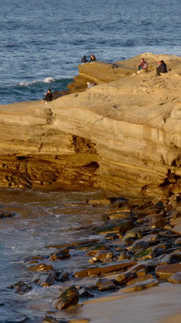 Elevated view of the cliffs, the surf and the ocean at La Jolla Cove.