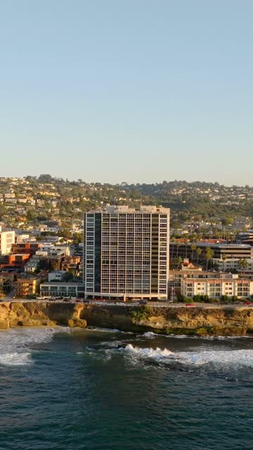 Aerial view of the cliffs, the surf and the ocean at La Jolla Cove.