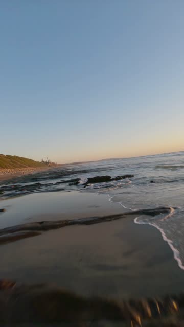 View from the water of the beach, the surf and the ocean at Swamis.