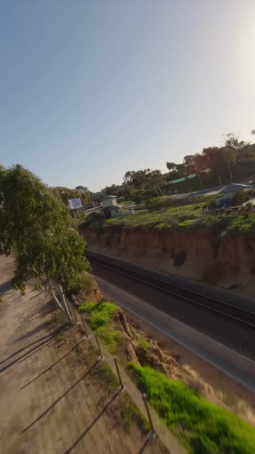 Low aerial view of the country inland, traffic and open country at Downtown Encinitas.