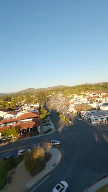 Low aerial view of the country inland, homes and the buildings at Covenant.