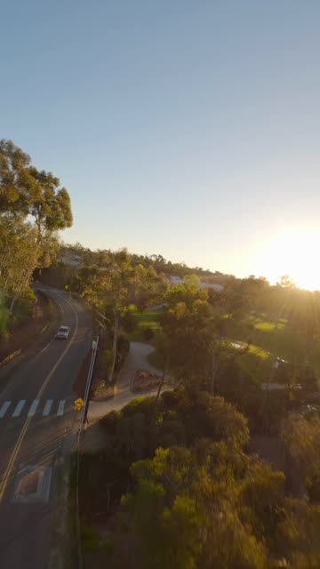 Low aerial view of a residential street, homes and traffic at Covenant.