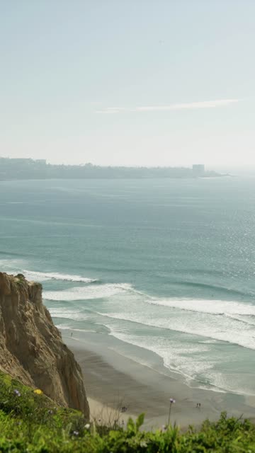 Elevated view of the cliffs, the surf and the ocean at Black’s Beach.