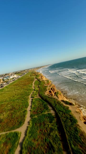 Aerial view of the cliffs, the surf and the ocean in Carlsbad.