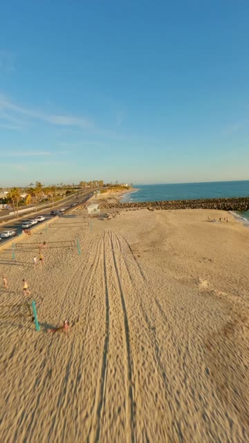 FPV drone video flying along Warm Waters Jetty Beach and Tamarack Beach in Carlsbad California featuring rolling ocean waves jetty coastline and the inlet near Agua Hedionda Lagoon | Vertical FPV Drone Video – 9
