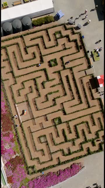 Aerial view of a park and open country at Flower Fields, with people walking.