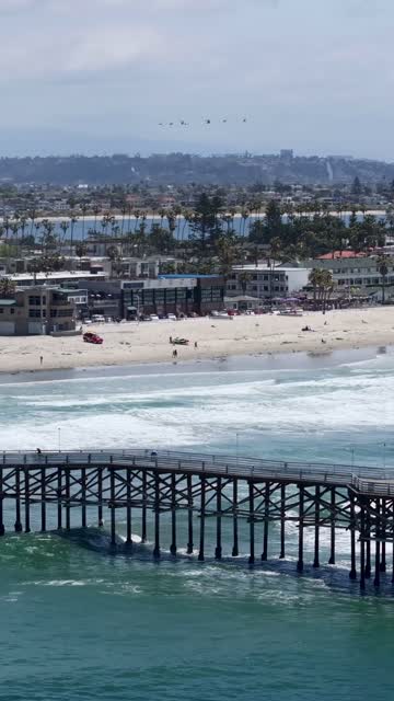 Aerial view of the beach, the surf and the pier in Pacific Beach.