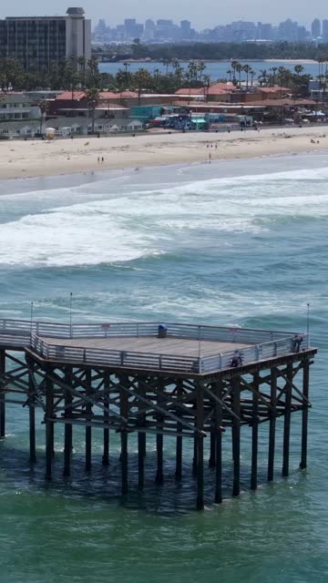 Aerial view of the beach, the surf and the pier in Pacific Beach.
