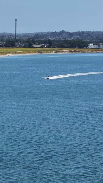 Aerial view of the beach, boats and the bay in Mission Bay, with boats out.