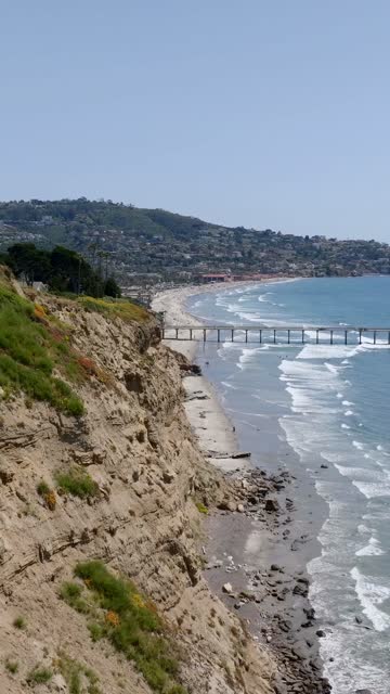 Aerial view of the cliffs, the surf and the pier at Black’s Beach.