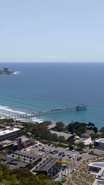 Aerial view of the beach, the surf and the pier at La Jolla Shores.
