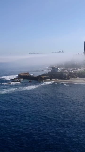Aerial view of the cliffs, the surf and the ocean at Village of La Jolla.
