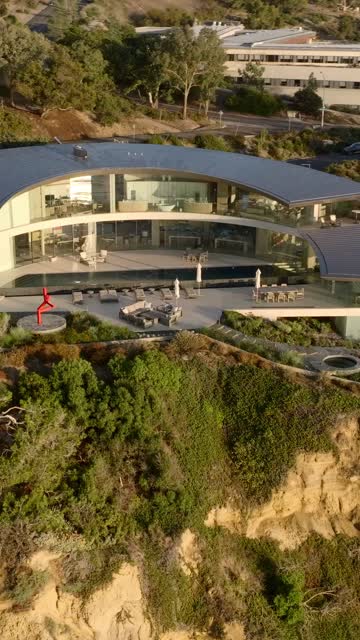 Low aerial view of the cliffs, homes and the buildings at Black’s Beach.