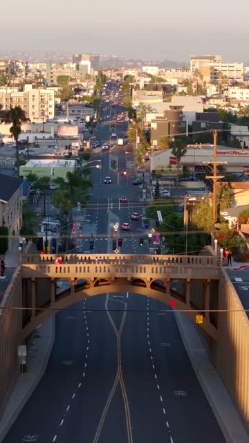 Aerial view of the downtown streets, the bridge and homes in North Park, with people walking.