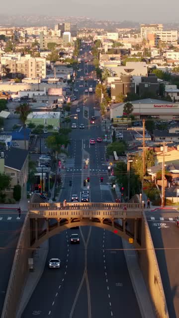Low aerial view of the downtown streets, the bridge and the buildings in North Park, with people walking.