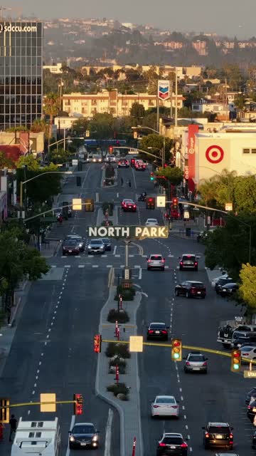 Low aerial view of the downtown streets, the buildings and the city in North Park, with people walking.