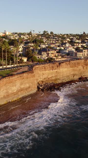 Aerial view of the cliffs, the surf and palm trees at Sunset Cliffs.