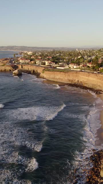 Aerial view of the cliffs, the surf and palm trees at Sunset Cliffs.