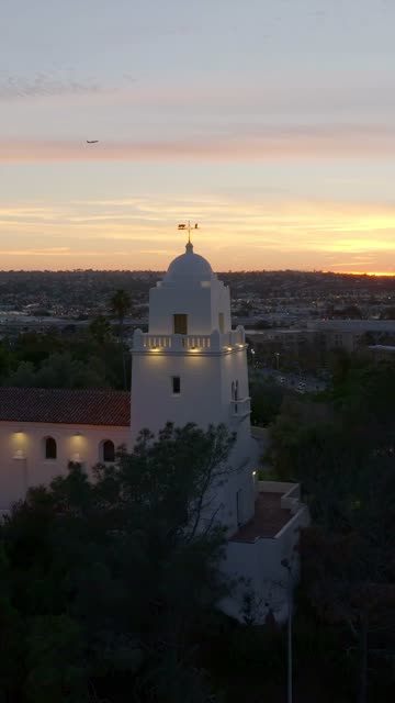 Vertical drone video of the Junípero Serra Museum in Presidio Park near Mission Hills San Diego California at sunset with warm golden light and historic architecture | Vertical Drone Video – 12
