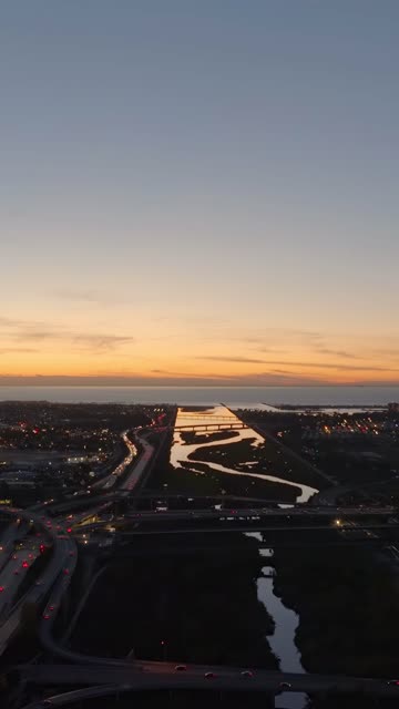 Sunset aerial drone video overlooking the San Diego River channel and ocean horizon over Mission Valley | Vertical Drone Video – 1