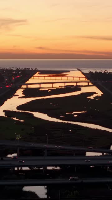 Sunset aerial drone video overlooking the San Diego River channel and ocean horizon over Mission Valley | Vertical Drone Video – 2