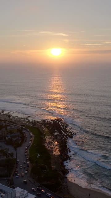 Aerial view of the cliffs, the ocean and traffic at La Jolla Cove.