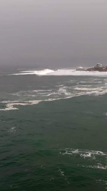 The cliffs, the surf and the ocean at La Jolla Cove.