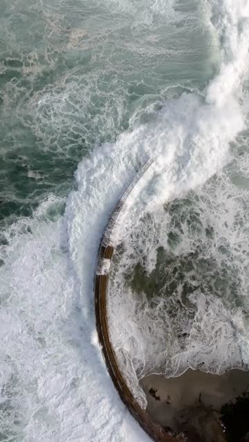 Aerial view of the cliffs, the surf and the ocean at La Jolla Cove.
