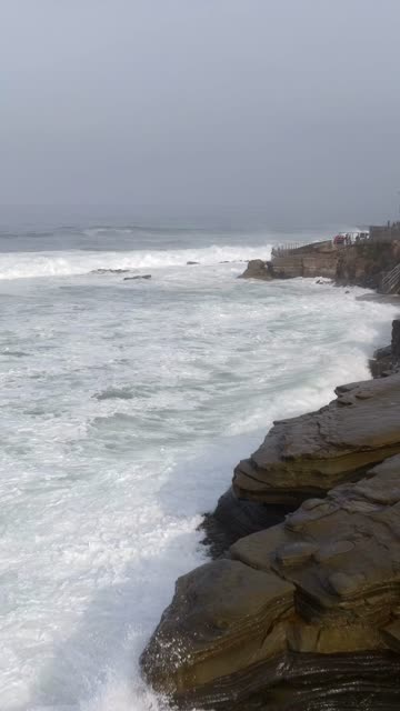 The cliffs, the surf and the ocean at La Jolla Cove.