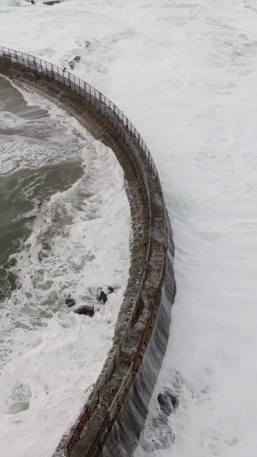 Aerial view of the beach, the surf and the ocean at La Jolla Cove.