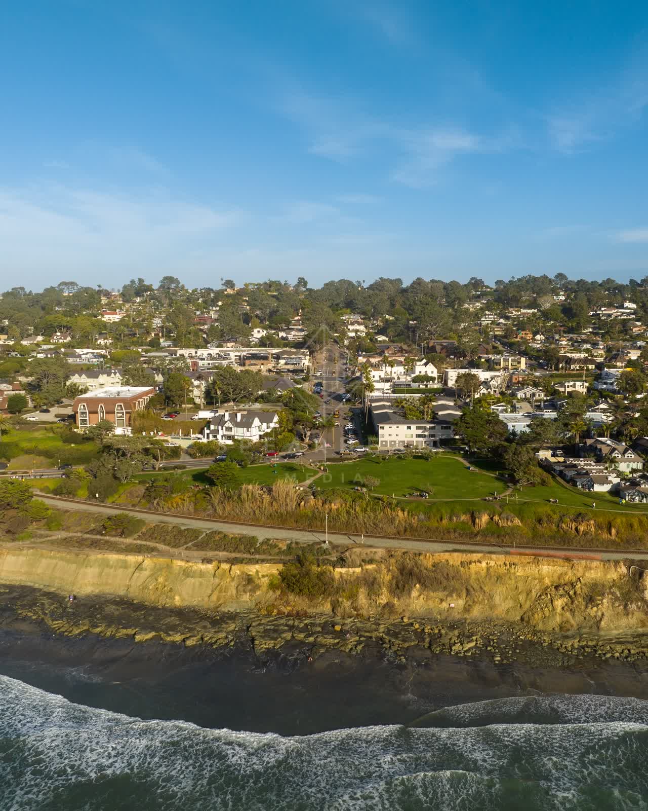 Aerial view of the cliffs, the surf and the ocean in Del Mar.