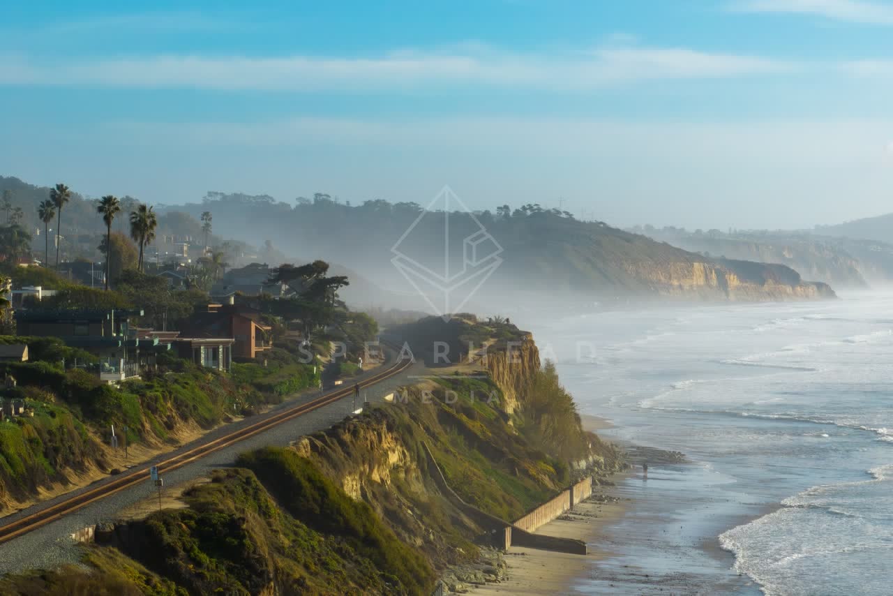Aerial view of the cliffs, the surf and palm trees in Del Mar.