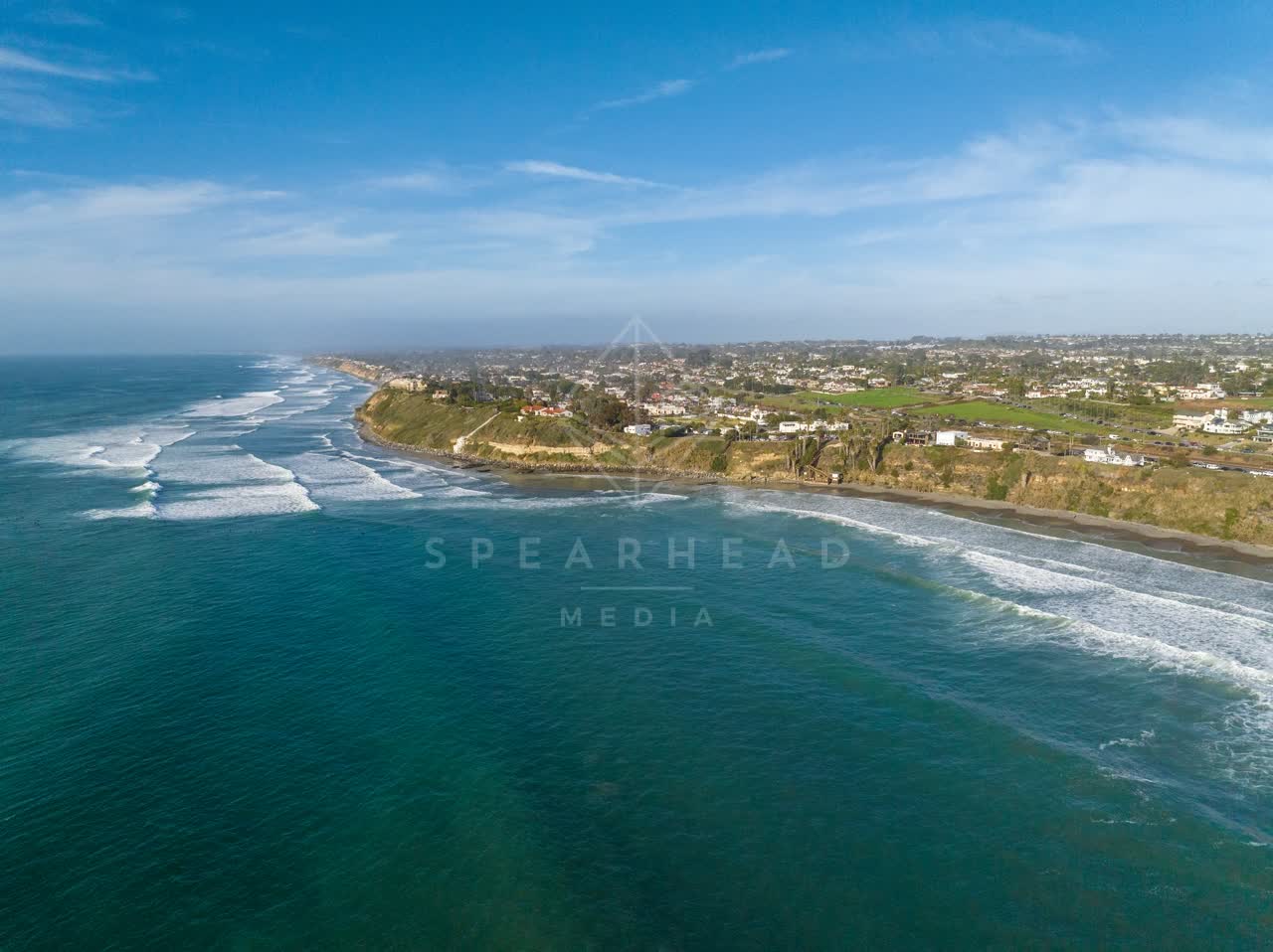 Aerial view of the cliffs, the surf and the ocean at Swamis.