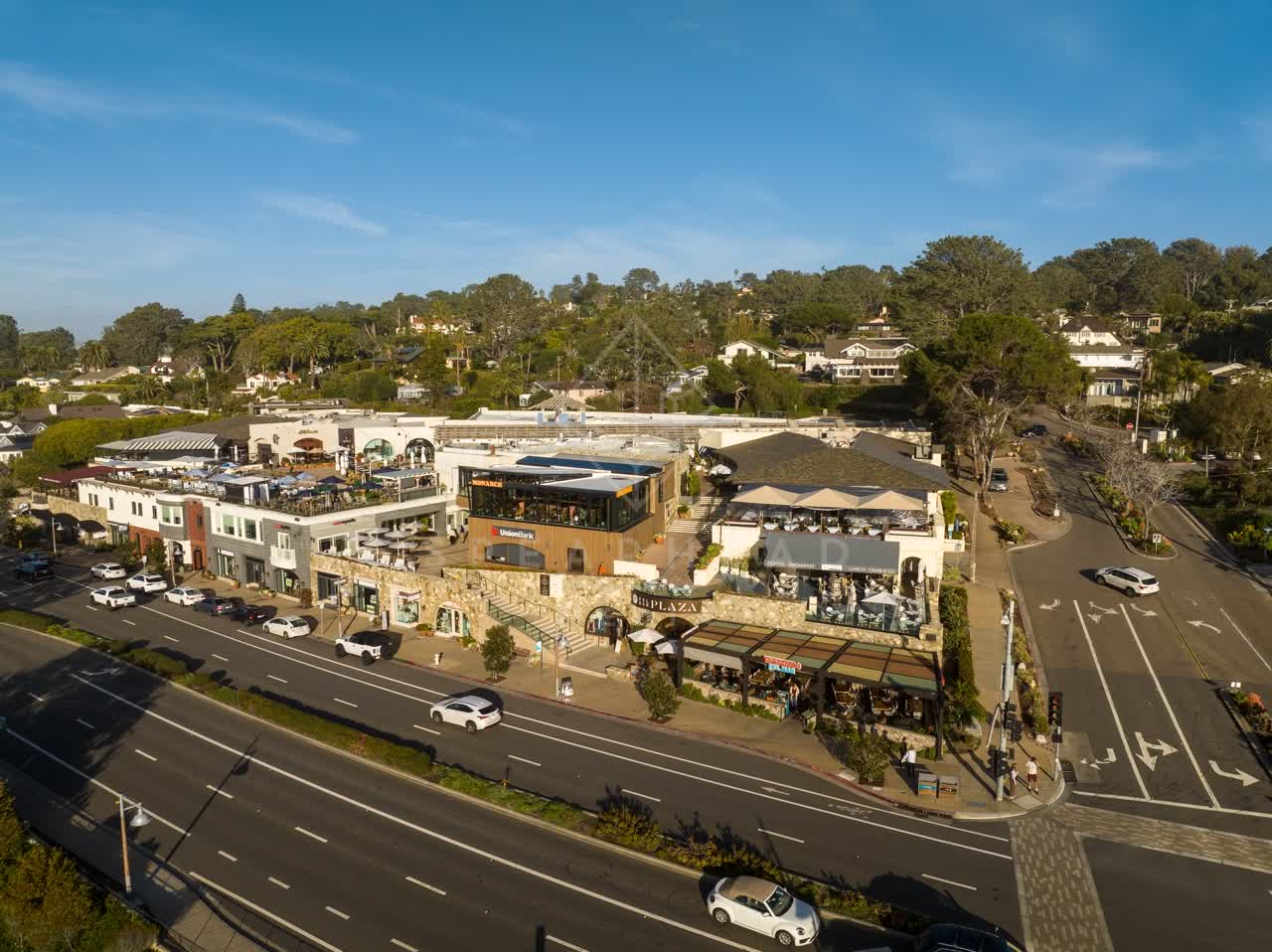 Aerial view of the downtown streets, homes and the buildings in Del Mar, with people eating outside.