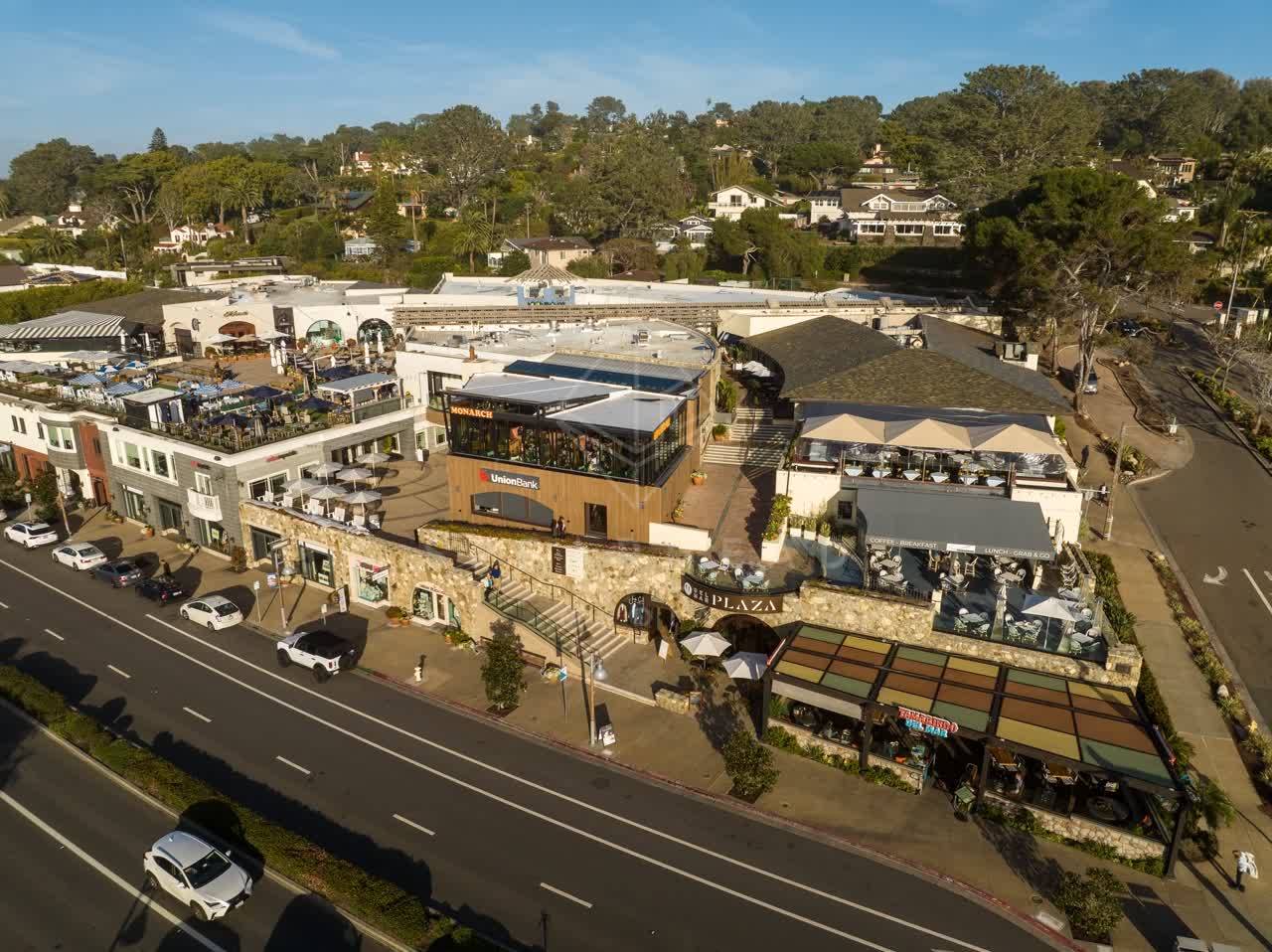 Low aerial view of the downtown streets, homes and the buildings in Del Mar.
