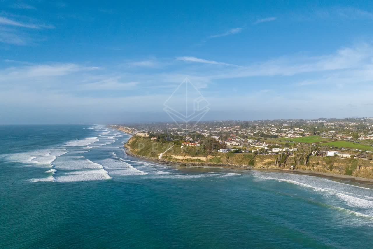 Aerial view of the cliffs, the surf and the ocean at Swamis.