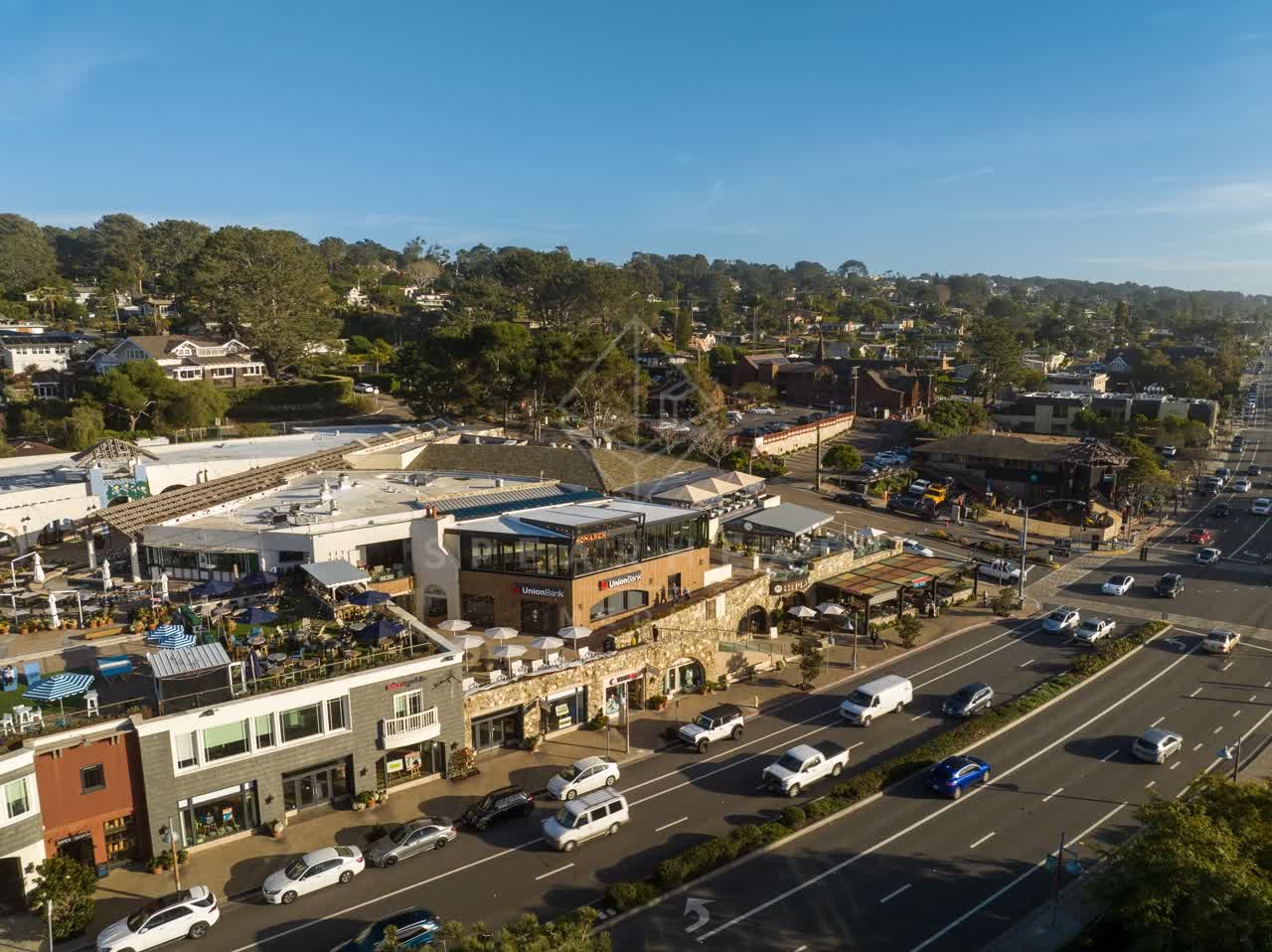 Low aerial view of the downtown streets, homes and the buildings in Del Mar.