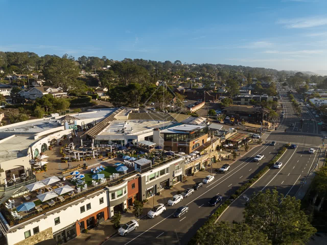 Aerial view of the downtown streets, homes and the buildings in Del Mar, with people eating outside.